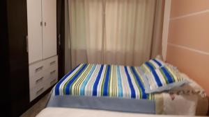 Cama ou camas em um quarto em Residência Familiar