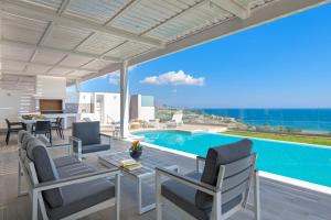 a villa with a swimming pool and a table and chairs at Villa Gaia in Lindos