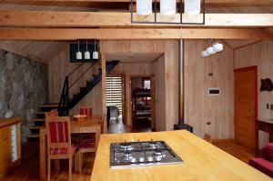 ein Wohnzimmer mit einem Tisch und einer Treppe in der Unterkunft El Descanso del Quijote in Riñinahue