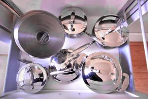 a group of pots and pans sitting on a shelf at Vieille Maison Rustique Espace Intéressant in Quebec City +23 photos