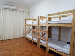 two bunk beds in a room with wooden floors at Hostel Orla de Tambaú in João Pessoa