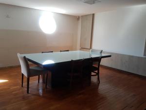 a table and chairs in an empty room at Hostel Orla de Tambaú in João Pessoa