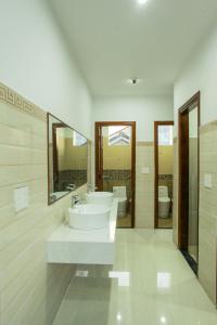 a bathroom with two sinks and two toilets at Cucumber Hostel in Hoi An