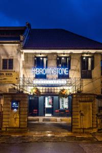 a building with a sign on the front of it at The Brownstone Hostel & Space in Ipoh