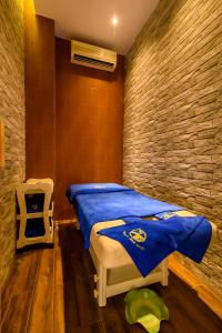 a bedroom with a bed with a blue blanket at Thanh Lich Royal Boutique in Hue +63 photos