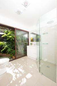 a bathroom with a glass shower and a toilet at A Suite Spot in the Hills in Mount Barker