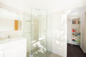 a bathroom with a glass shower and a sink at A Suite Spot in the Hills in Mount Barker