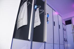 a row of lockers in a locker room with towels at Nap Corner - Cornerstay - Nap for Sale in Male City