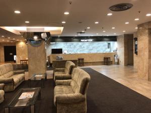 a waiting room with couches and a projection screen at Narita U-City Hotel in Narita