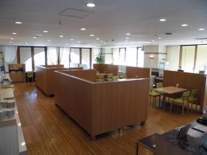 a waiting room with desks and tables and windows at Narita U-City Hotel in Narita