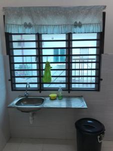 a bathroom with a sink and a large window at Rumah Melaka in Melaka