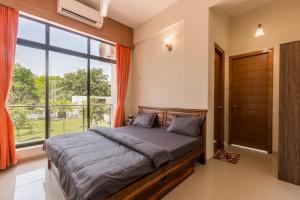 Giường trong phòng chung tại StayVista's Greenwoods Villa 6 - City-Center Villa with Private Pool, Terrace, Lift & Ping-Pong Table +11 ảnh