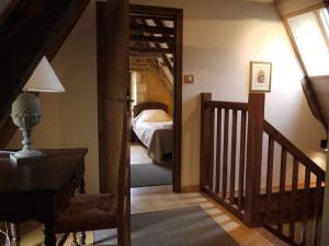 a room with a bedroom with a bed and a staircase at Maison Milou in Beynac-et-Cazenac