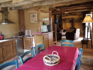 a kitchen with a table with a basket on it at Maison Milou in Beynac-et-Cazenac