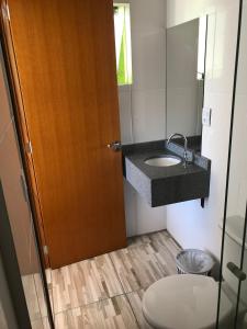 a bathroom with a sink and a toilet at Apart Hotel Alegrete in Alegrete