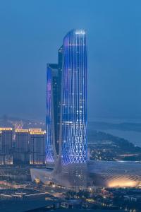 a rendering of a tall building in a city at night at Jumeirah Nanjing Hotel in Nanjing