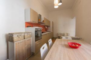 a kitchen and dining room with a wooden table at Villetta Angela in Torre San Giovanni Ugento
