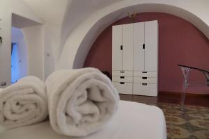 a pile of towels on a bed in a room at The House in Catania +119 photos