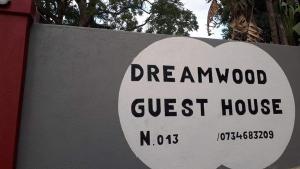 a sign that reads disregard amwood guest house at Dreamwood Guest House in Nelspruit