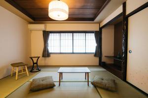 a living room with a table and a window at Wacasa TABI-NE in Kanazawa