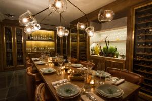 a dining room with a long table and lights at The Ampersand Hotel in London