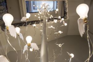 a vase with white flowers in front of a mirror at The Ampersand Hotel - Small Luxury Hotels of the World in London