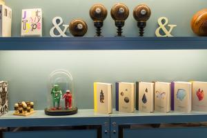 a shelf with books and other items on it at The Ampersand Hotel - Small Luxury Hotels of the World in London