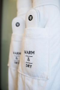 a white towel with the words warm and dry written on it at The Ampersand Hotel - Small Luxury Hotels of the World in London