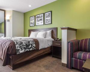 a hotel room with a bed and a couch at Sleep Inn Columbia in Columbia +24 photos