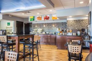 a fast food restaurant with a bar and chairs at Quality Inn & Suites Aiken in Aiken