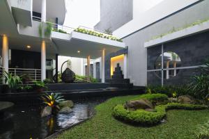 a house with a koi pond in the yard at Rozelle by d'best hospitality in Cituja