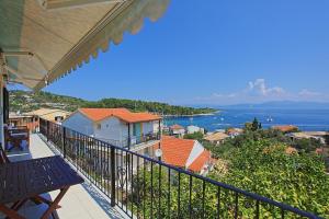 a balcony of a house with a view of the ocean at Villa Thea Antonis in Gaios