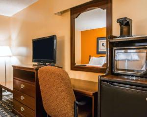 a room with a desk with a computer and a mirror at Econo Lodge Eufaula in Eufaula