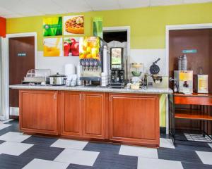 a kitchen with wooden cabinets and a counter top at Quality Inn Prattville I-65 in Prattville