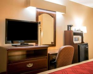 a hotel room with a desk with a monitor and a chair at Econo Lodge Eufaula in Eufaula