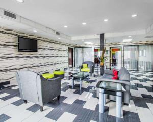 a lobby with chairs and a tv on a wall at Quality Inn Prattville I-65 in Prattville