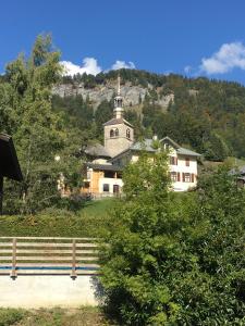 una iglesia sentada en la cima de una colina con un edificio en Chambres d’Hôtes les Hermines, en Saint-Nicolas-la-Chapelle