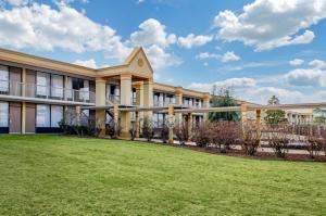 a building with a lawn in front of it at Quality Inn University Area in Troy