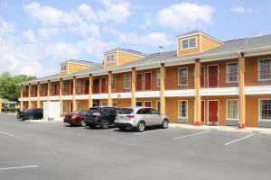 a large building with cars parked in a parking lot at Quality Inn Albertville US 431 in Albertville