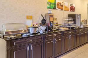 a kitchen with a counter with food on it at Quality Inn University Area in Troy