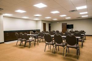 une salle de conférence avec des tables et des chaises et un tableau blanc dans l'établissement Sleep Inn & Suites Marion - Military Institute, à Marion