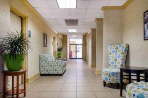 a hallway of a hospital with chairs and tables at Quality Inn University Area in Troy