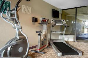a gym with a treadmill and a tv in a room at Quality Inn University Area in Troy