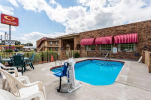 a swimming pool with chairs next to a building at Econo Lodge & Suites Brinkley in Brinkley