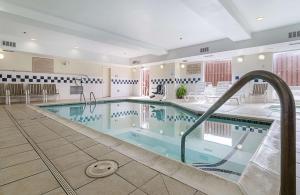 a pool in a hotel room with a swimming pool at Quality Suites in Springdale