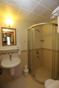 a bathroom with a shower and a sink at Eden Hotel in Bodrum City