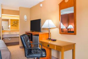 a hotel room with a desk with a computer and a chair at Econo Lodge Jacksonville near Little Rock Air Force Base in Jacksonville