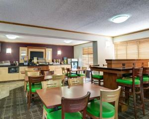 a restaurant with tables and chairs and a kitchen at Quality Inn Fort Smith I-540 in Fort Smith
