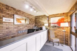 a waiting room with a counter and a chair at Comfort Inn Dubbo City in Dubbo