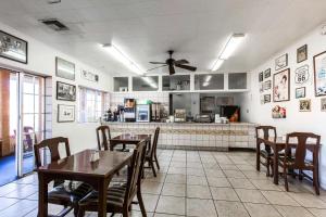 a restaurant with tables and chairs and a kitchen at Rodeway Inn Kingman Route 66 in Kingman